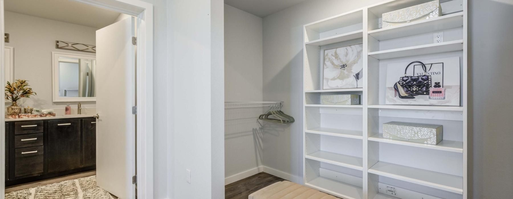 a room with a bed and a shelf with books