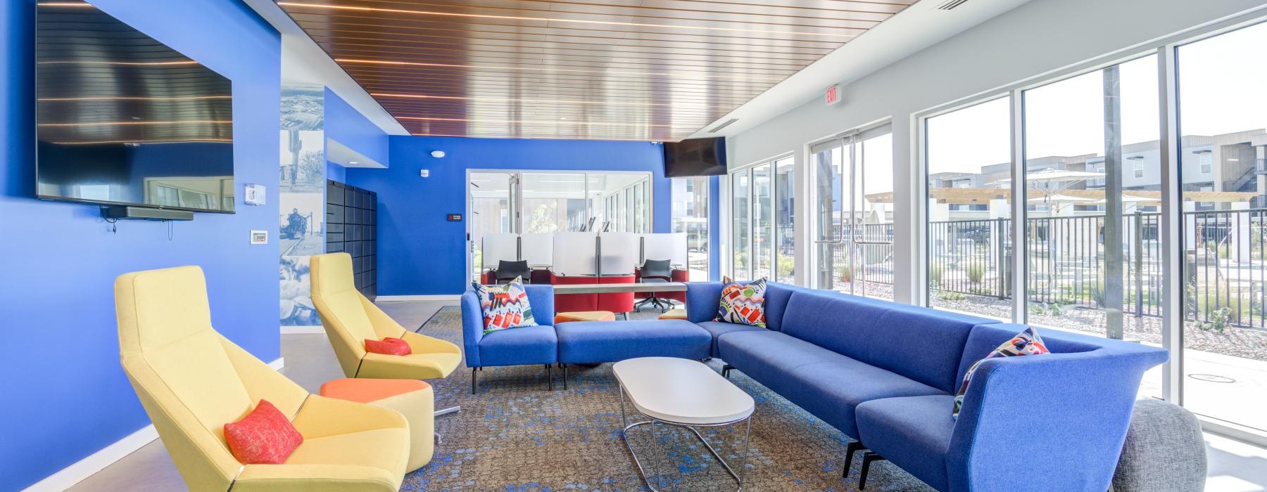 a room with blue couches and a table